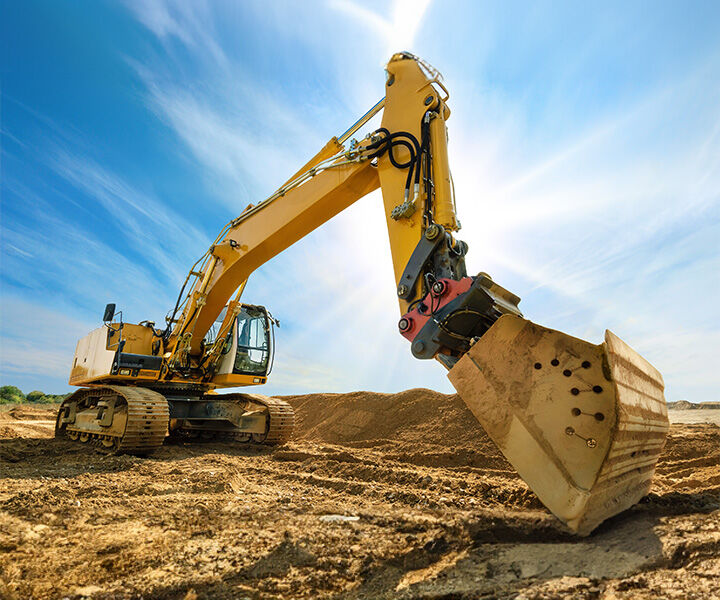 Excavator digging dirt at an outdoor construction site