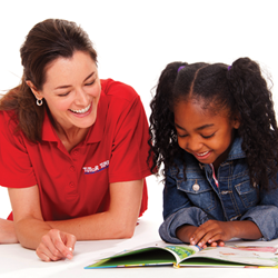 Teacher and child reading on floor