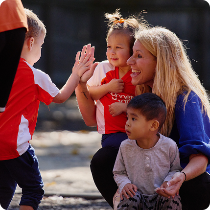 Teacher giving kids high five outside