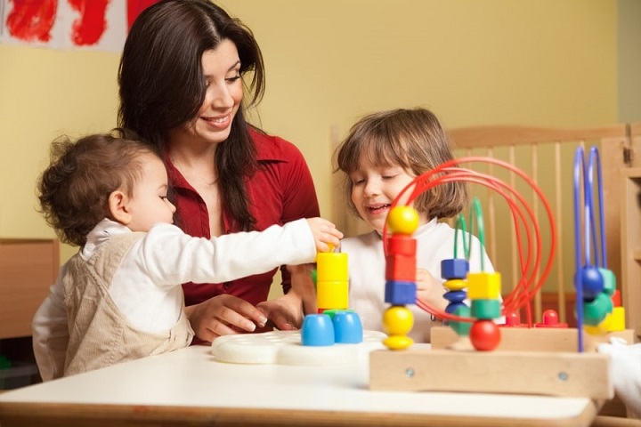 Teacher and children playing with toys