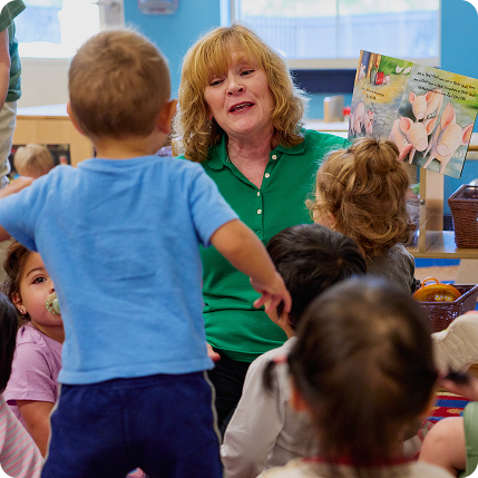 Teacher reading to group of toddlers