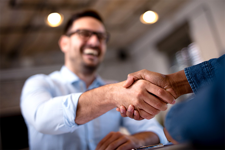 Man shaking another hand