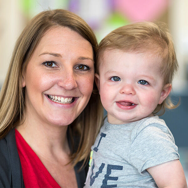 Teacher holding little boy