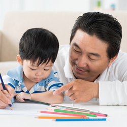 dad and son writing