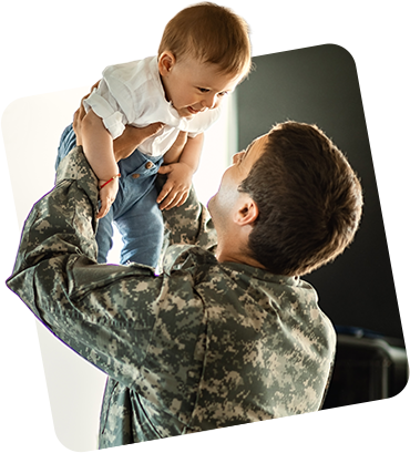 Service member holding baby up over his head and baby and dad are smiling
