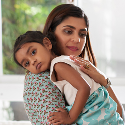 mom holding daughter