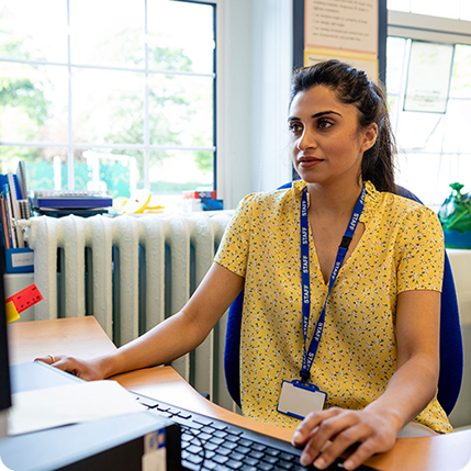 School director working at computer
