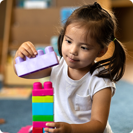 Little girl playing with stackable toys