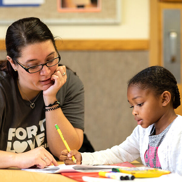 Teacher helping student with work