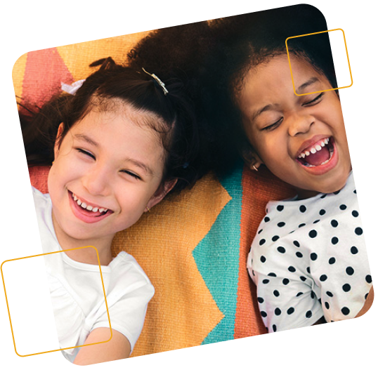 Two girls laying down smiling