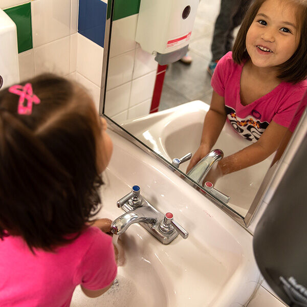 Little girl washing hands