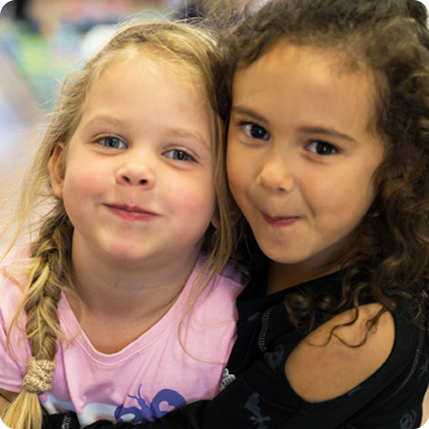 Two girls hugging and smiling
