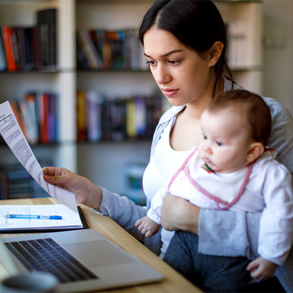 Mom working at laptop with child on her lap