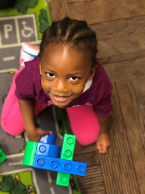 pre-k girl building legos